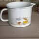 Vintage enamelled white metal milk jug with fruits.