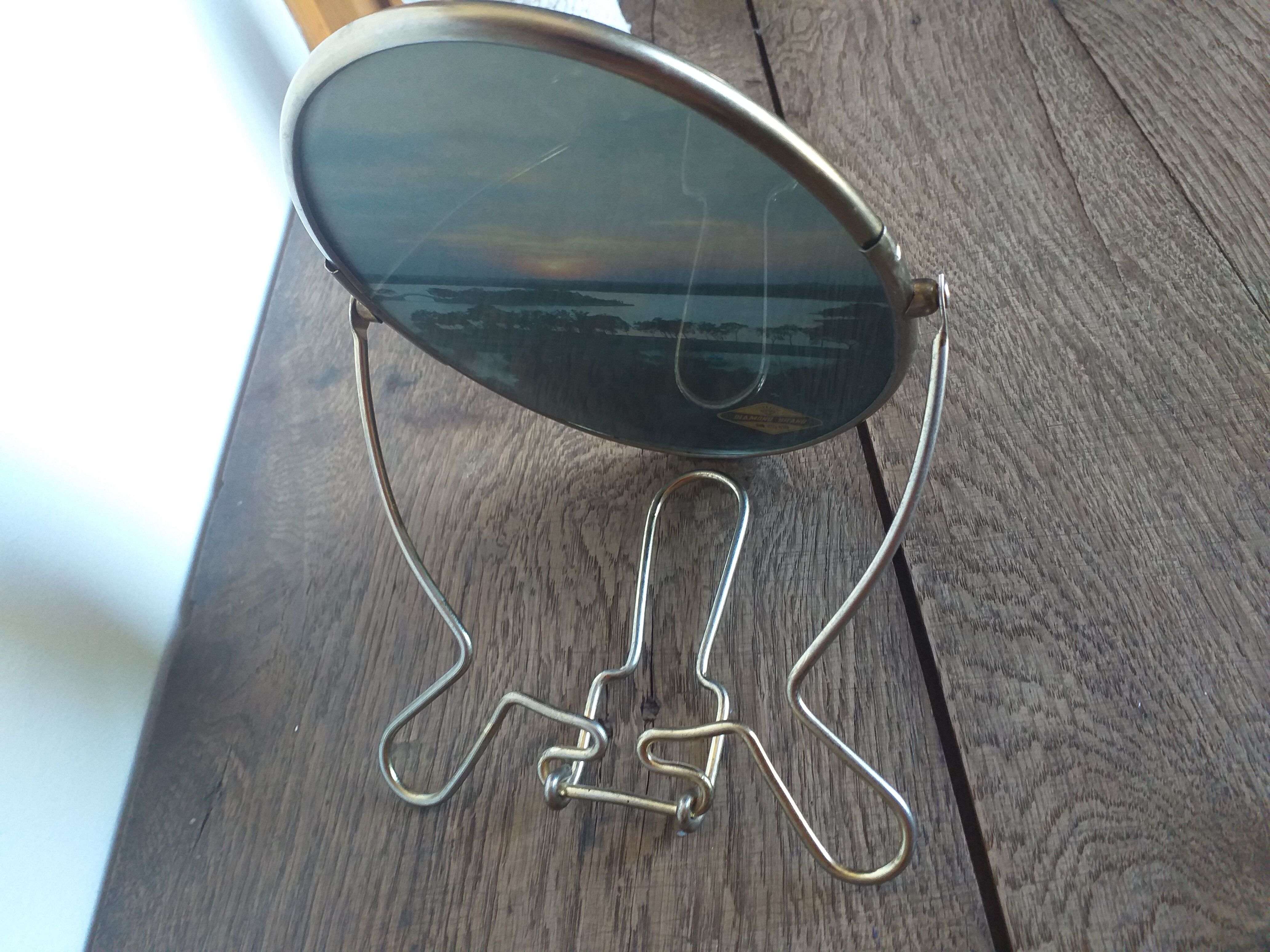 Vintage oval mirror on suspended stand