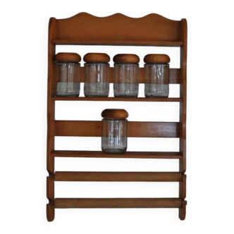Brown wooden wall spice rack with a set of 6 glass jars, 1950s vintage style.