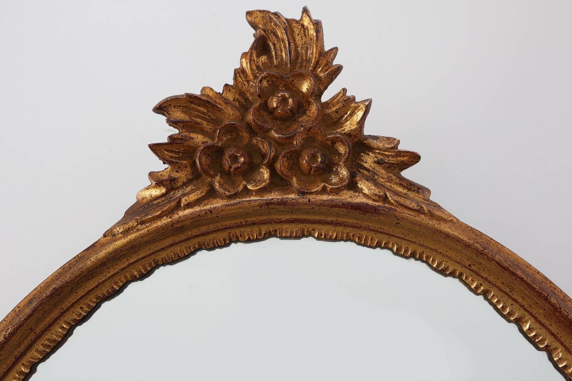 20th Century Louis XVI style giltwood mirror with ornate crest, France