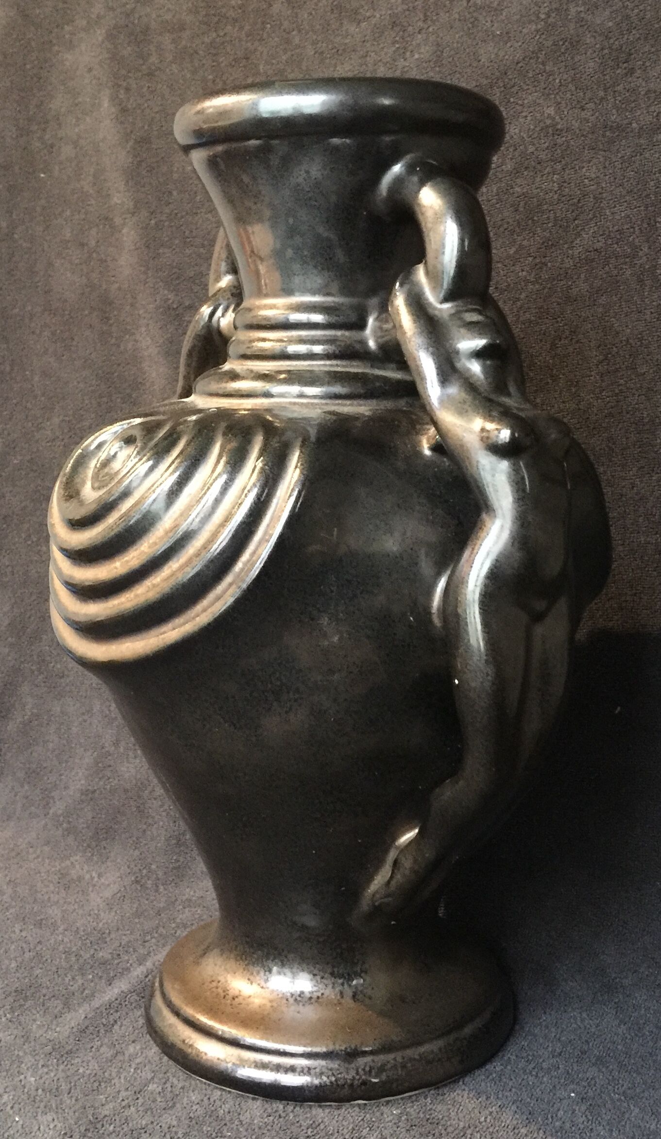 Black ceramic vase caught in naked women's bodies