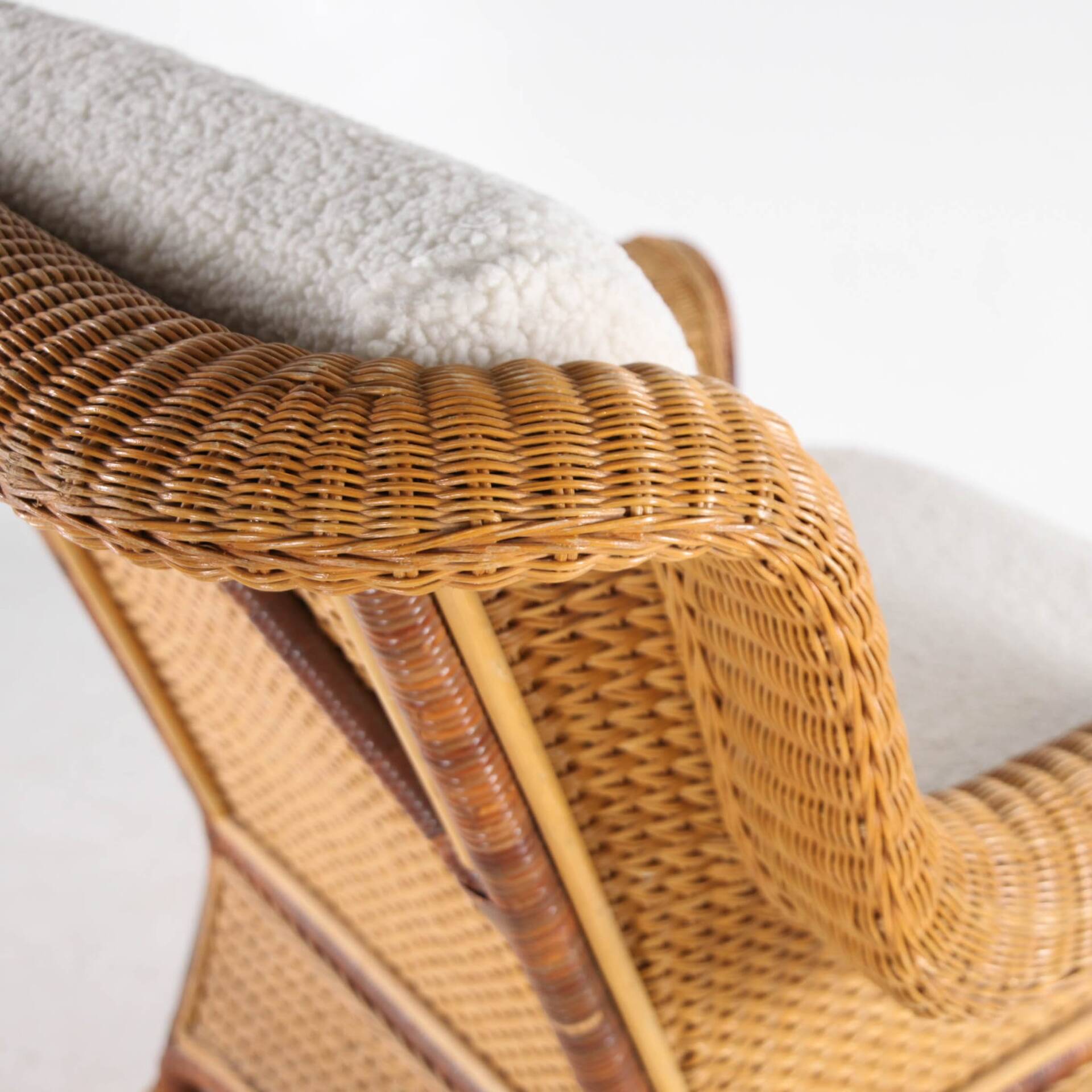 Large wicker armchair and its ottoman