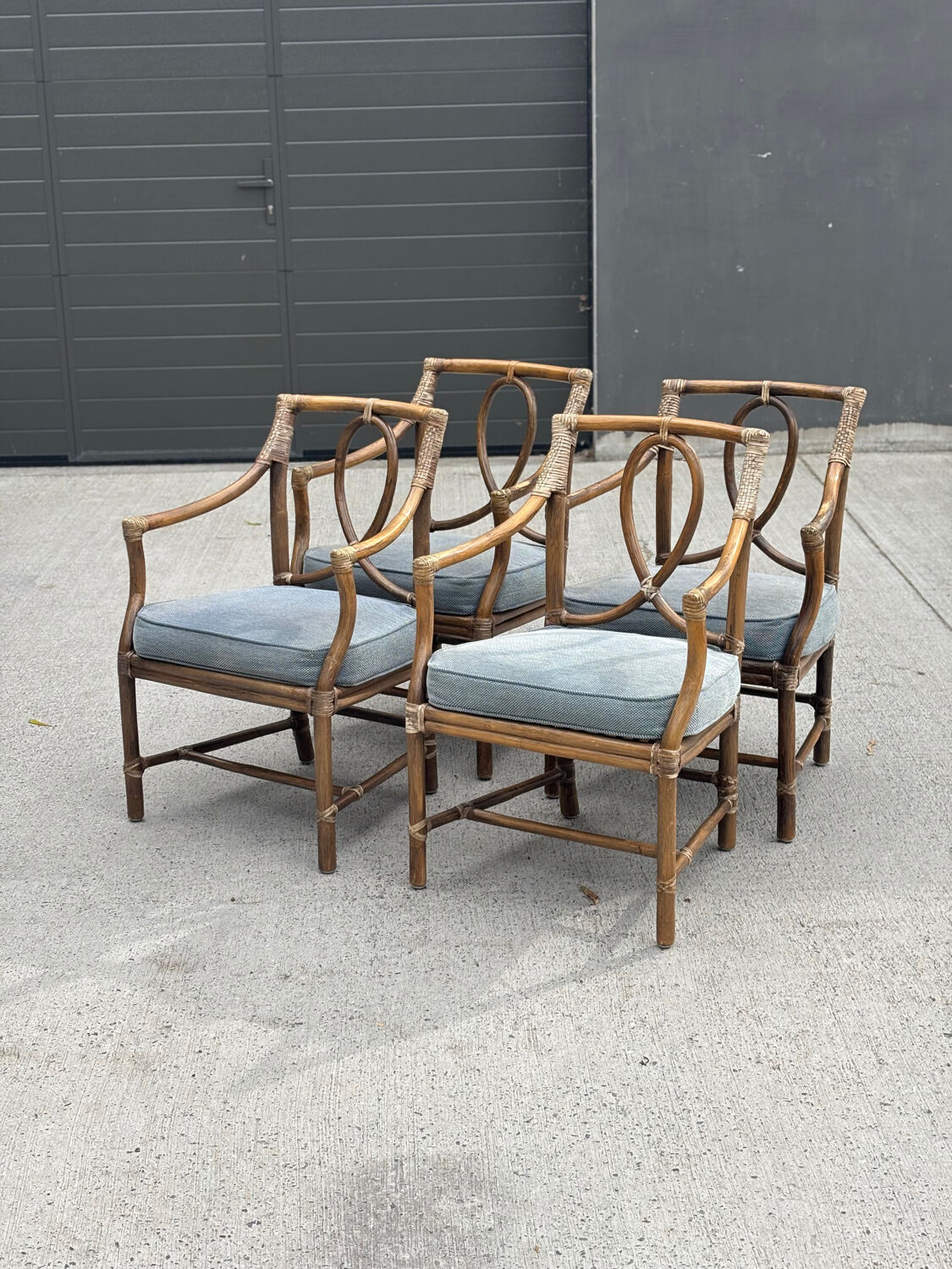 Set of 4 vintage McGuire rattan chairs with cushions.