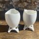 Antique porcelain egg cups in shell shape.
