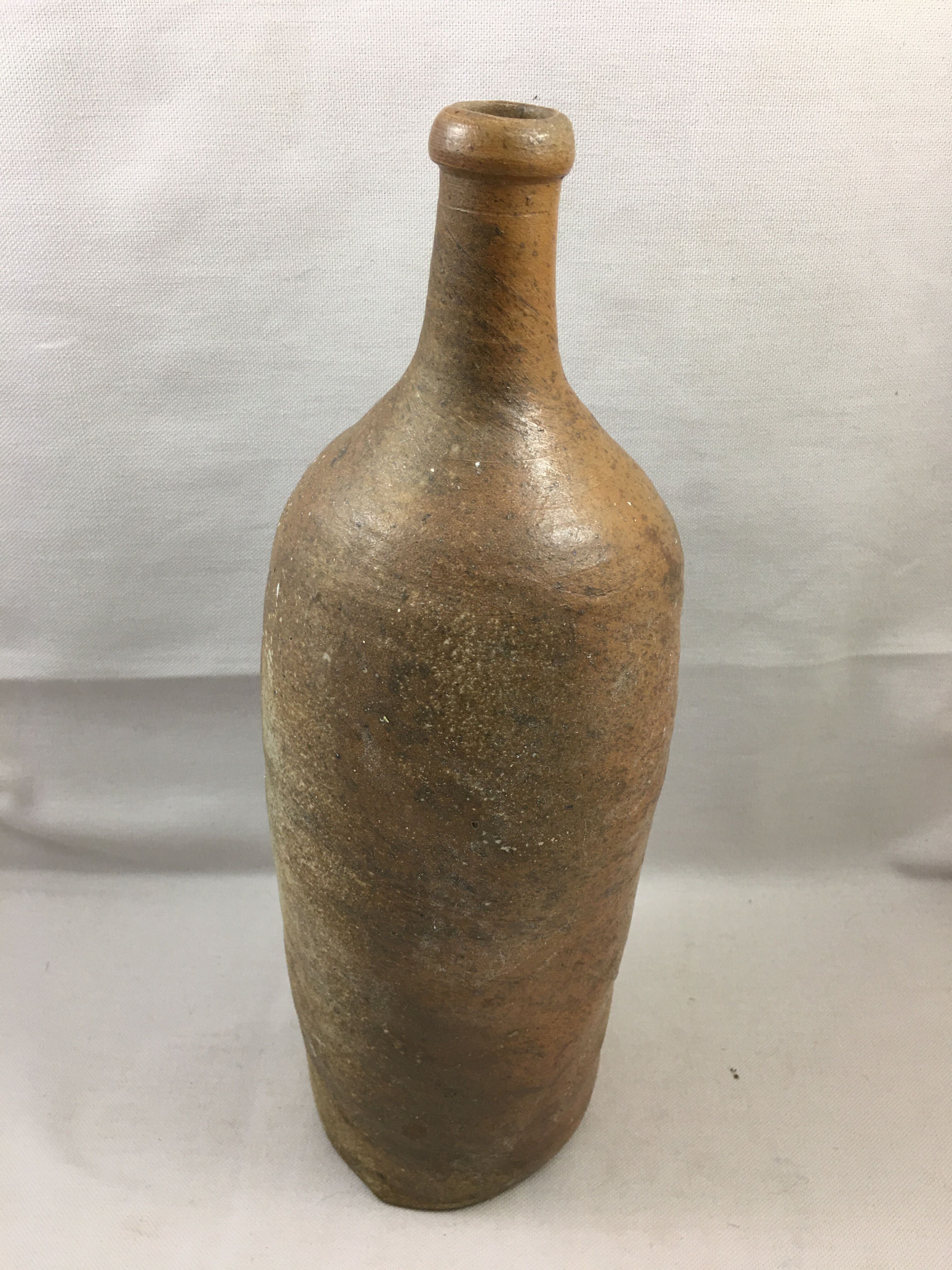 Old bottle in varnished sandstone glazed vintage