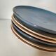 Set of 6 cream and grey-blue glazed earthenware plates.