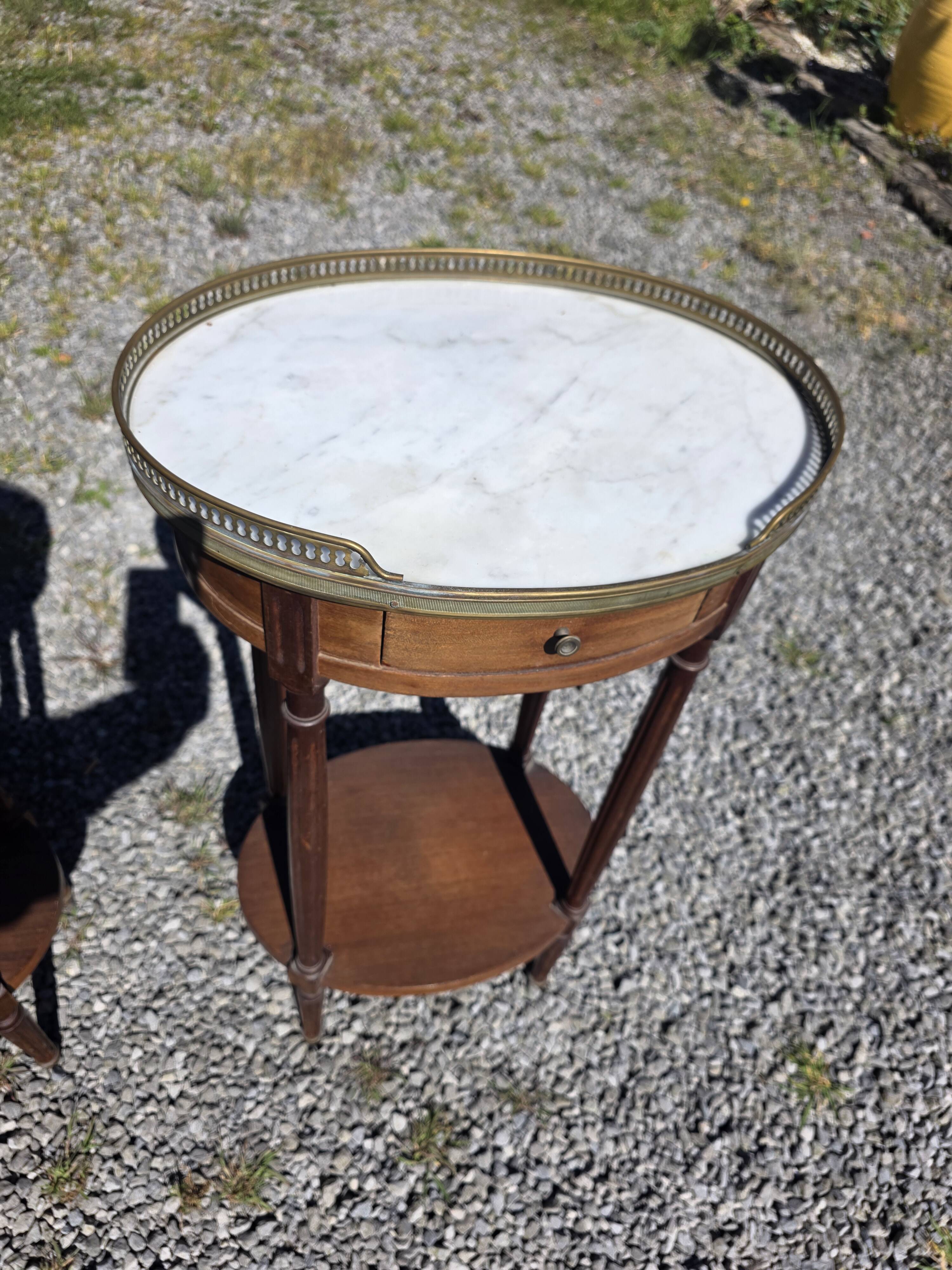 Pair of Louis XVI style bedside tables in mahogany, with marble tops.