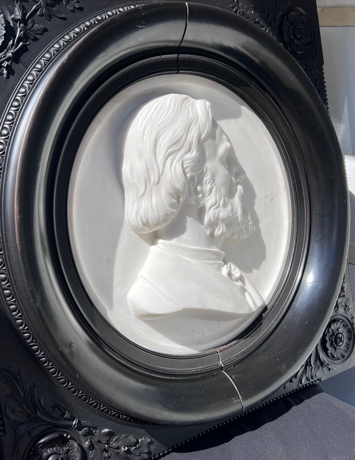 Bas-relief in marble and carved ebony signed Jouffroy, 1873