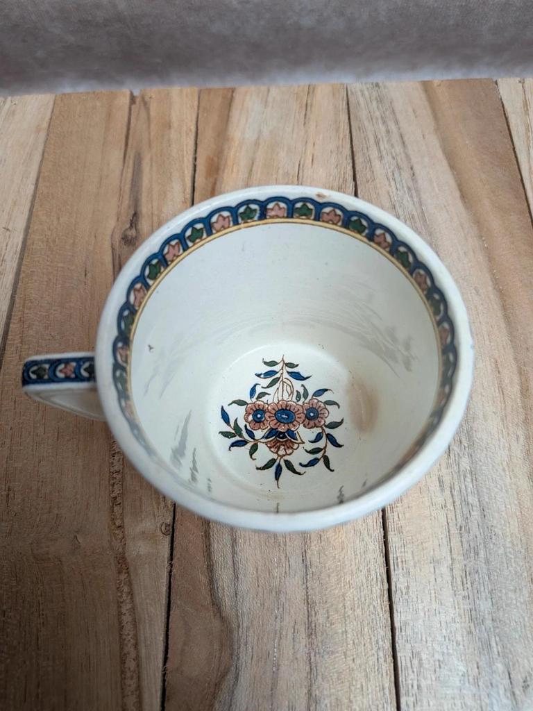 Antique ironstone cup from Sarreguemines with polychrome decoration.