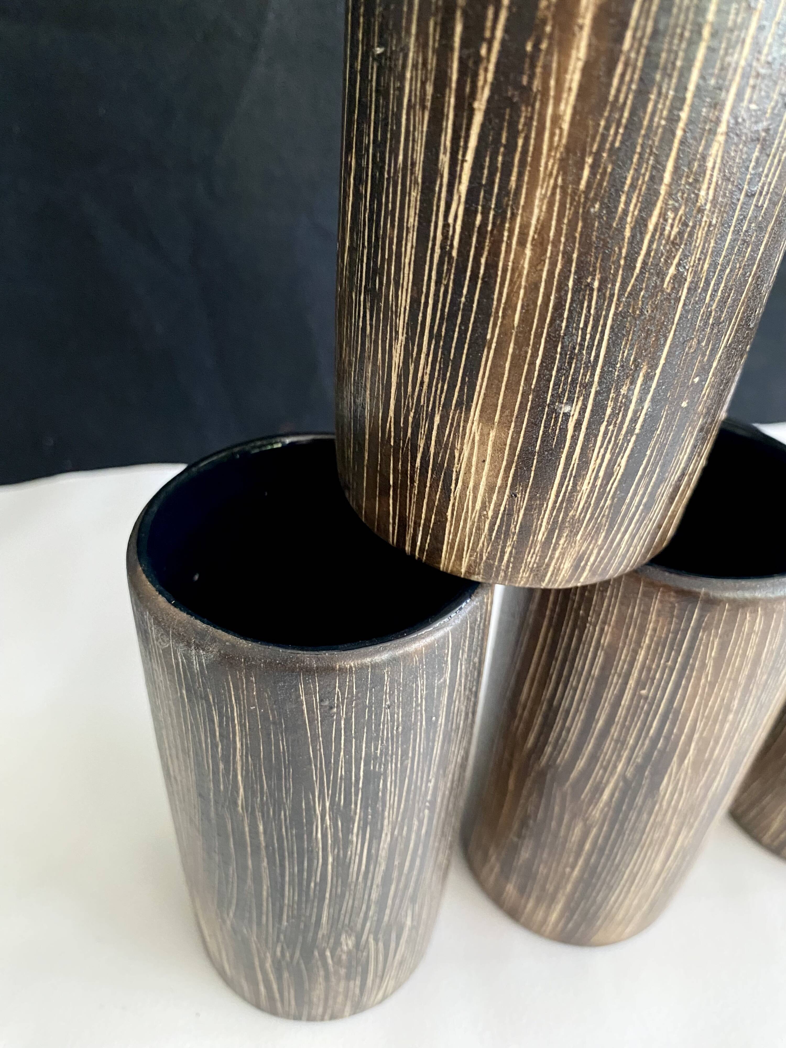 Six terracotta glasses, matt and glazed