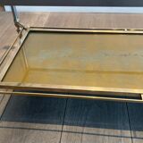 Coffee table in brass, brushed steel, glass, and gilded eglomisé mirror from Maison Jansen.