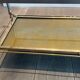 Coffee table in brass, brushed steel, glass, and gilded eglomisé mirror from Maison Jansen.