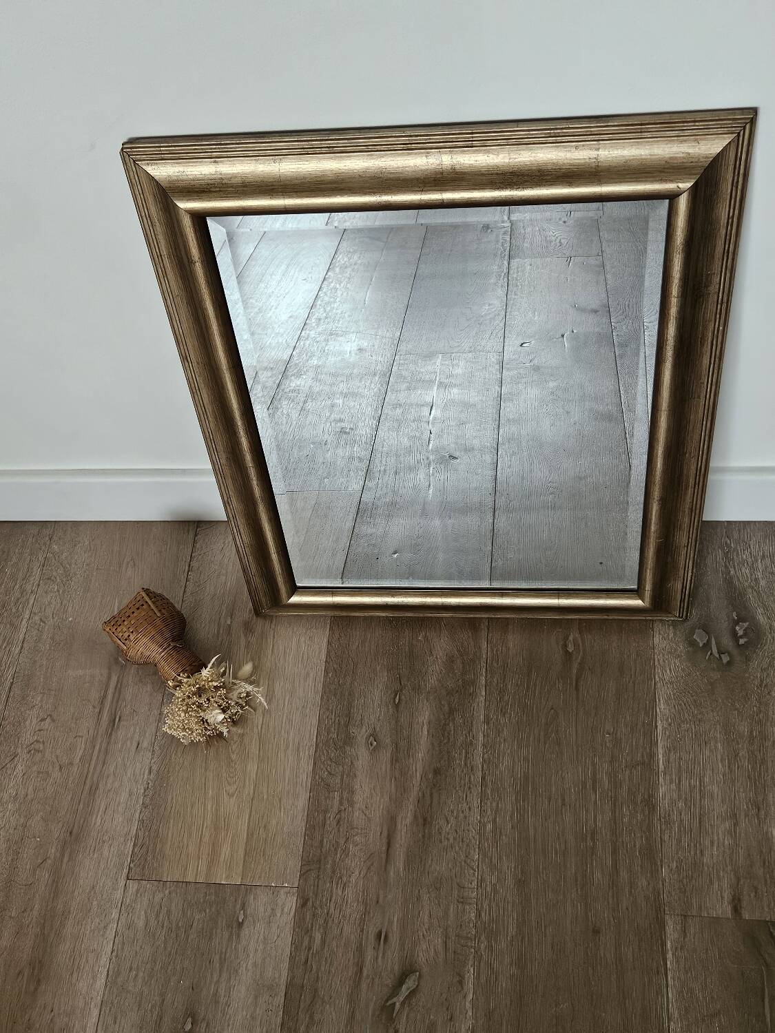Beveled mirror under gold frame