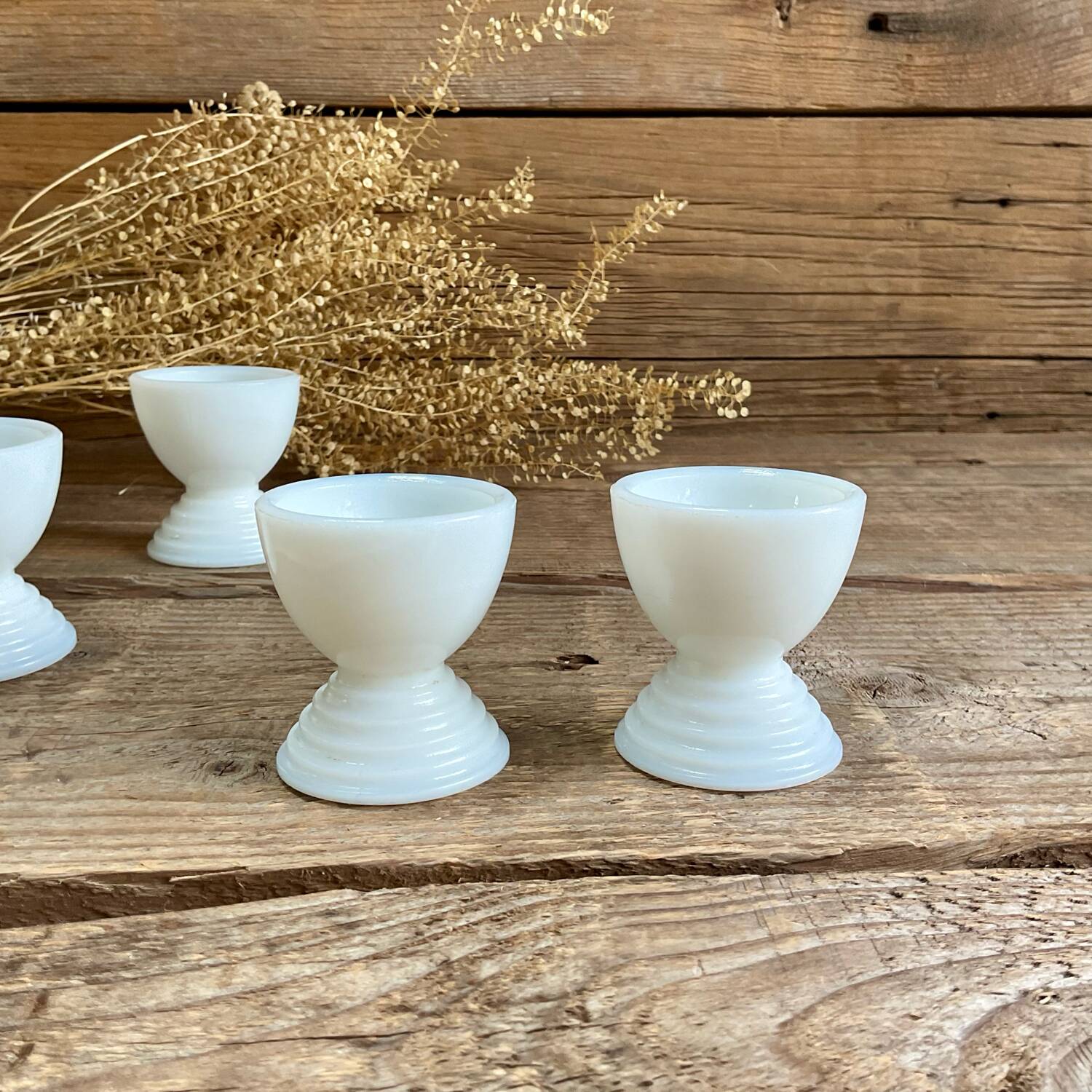 4 egg cups in white opaline glass