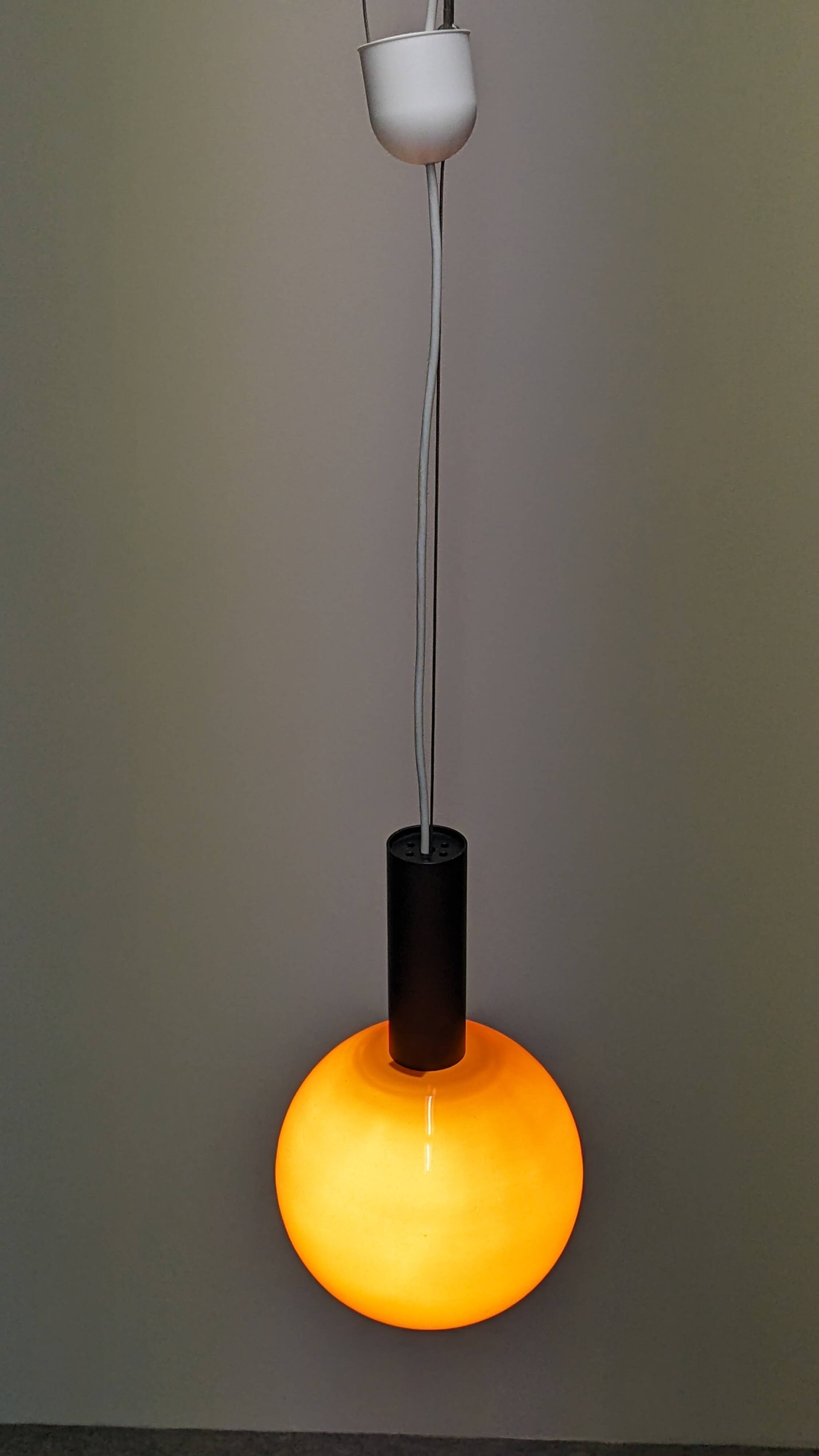 Pair of orange opaline ball pendants by Parscot, France circa 1970.