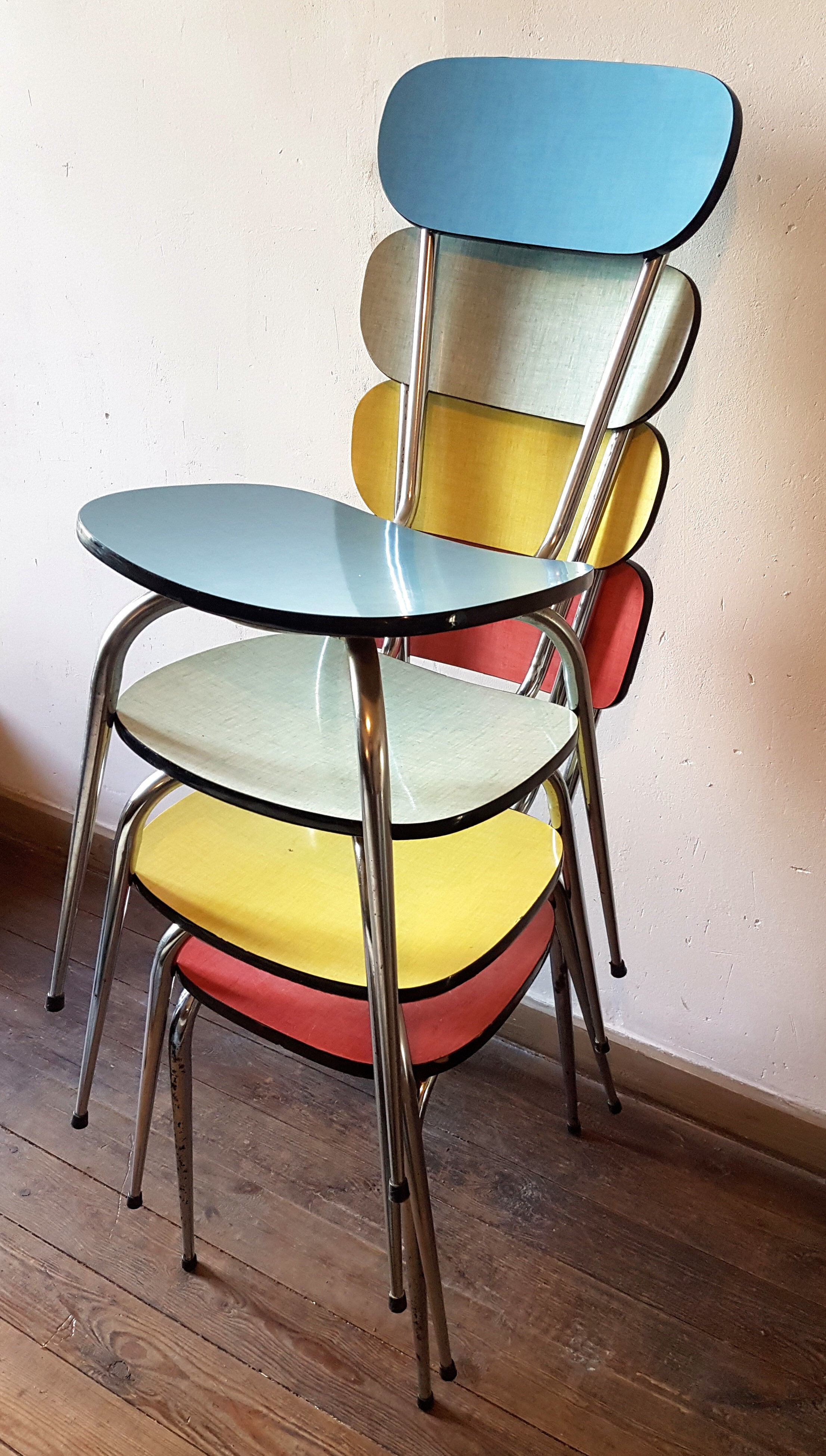 Four formica chairs in different colors