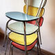 Four formica chairs in different colors