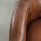 Sheepskin clubarmchair with beautiful patina finished with decorative nails