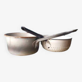 Gray saucepan and white enameled sheet metal colander