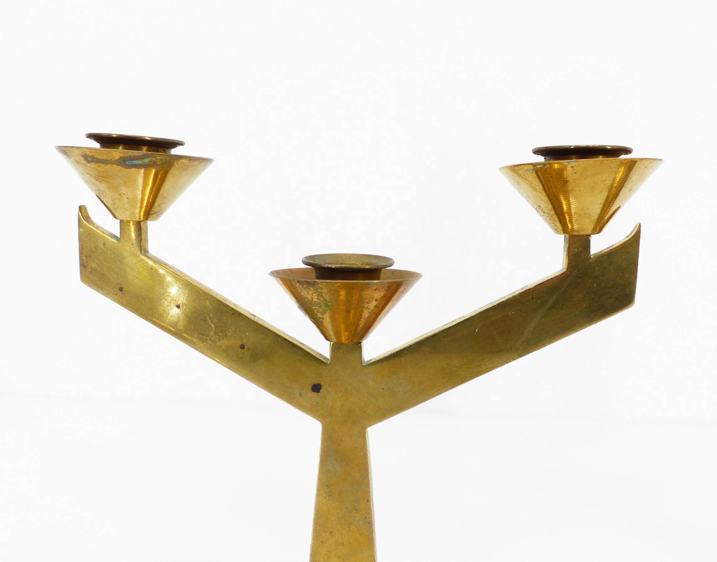 Pair of modernist three-armed solid brass candlesticks, circa 1960