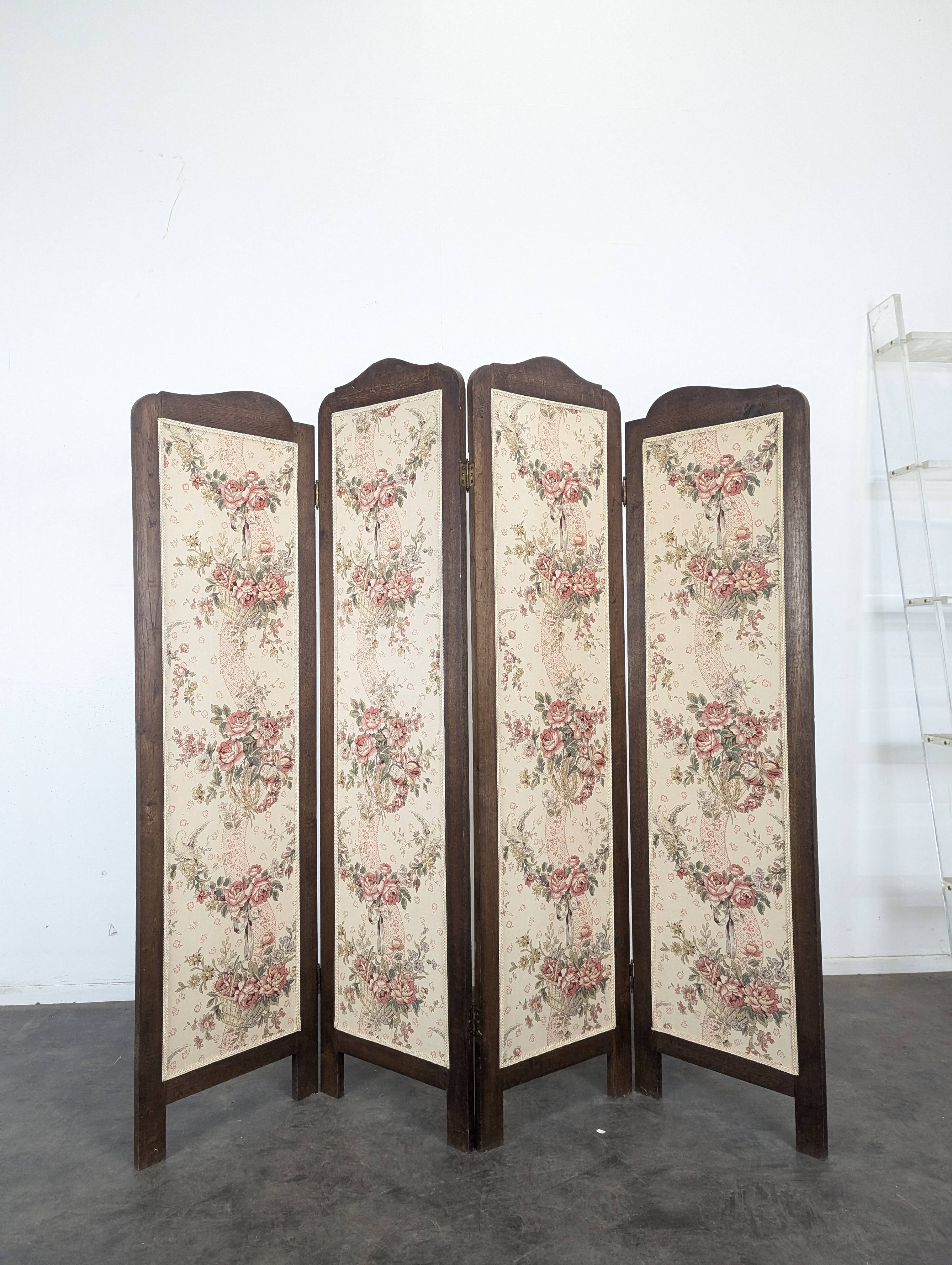 Four-panel oak screen adorned with floral upholstery from the 1930s.