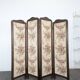 Four-panel oak screen adorned with floral upholstery from the 1930s.