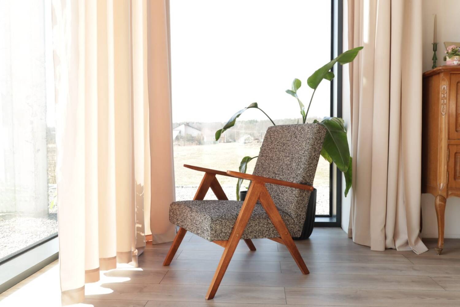 Vintage design armchair in mixed black fabric, walnut-coloured wood.