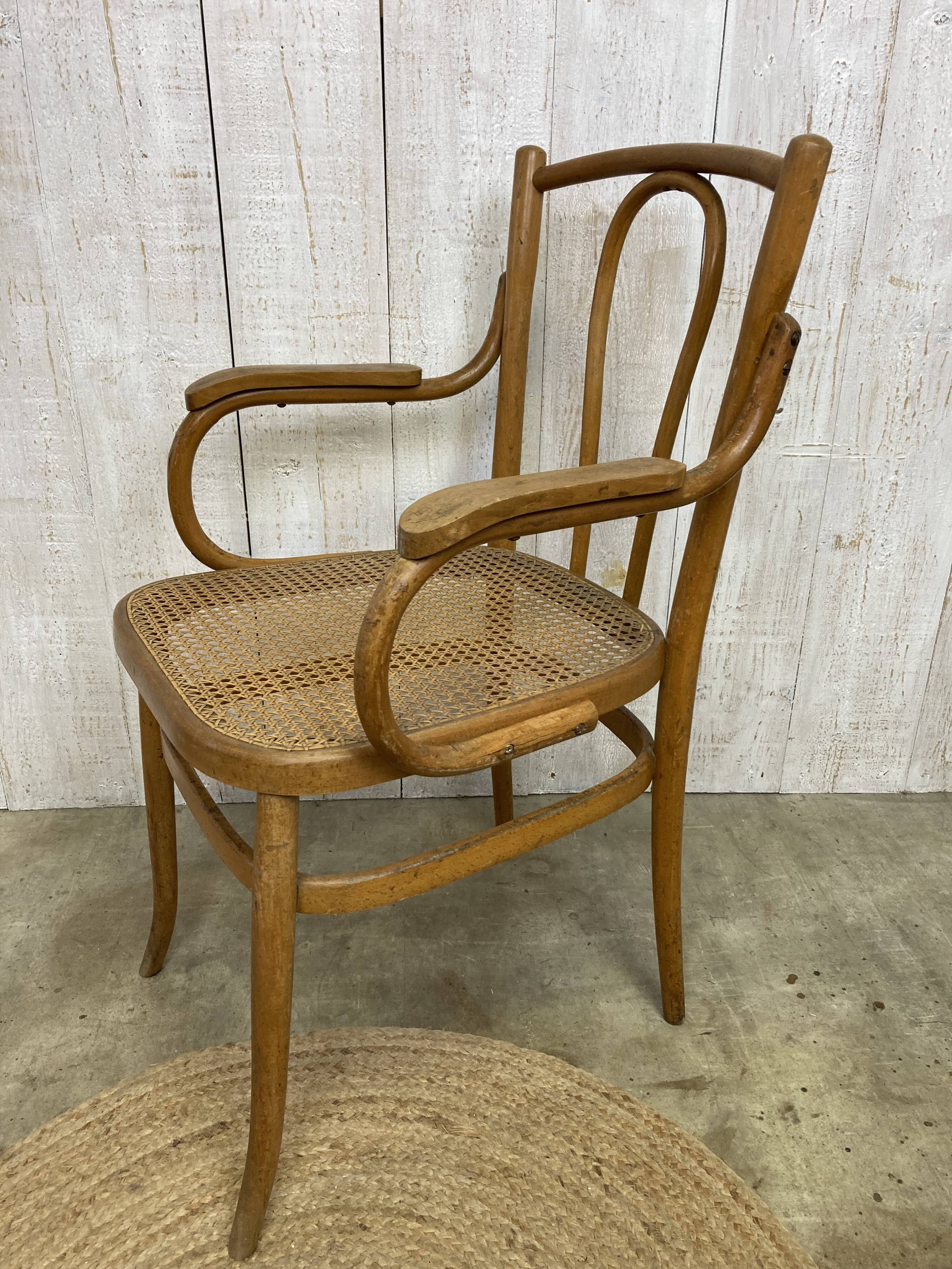 Curved wood and cane armchair
