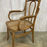 Curved wood and cane armchair
