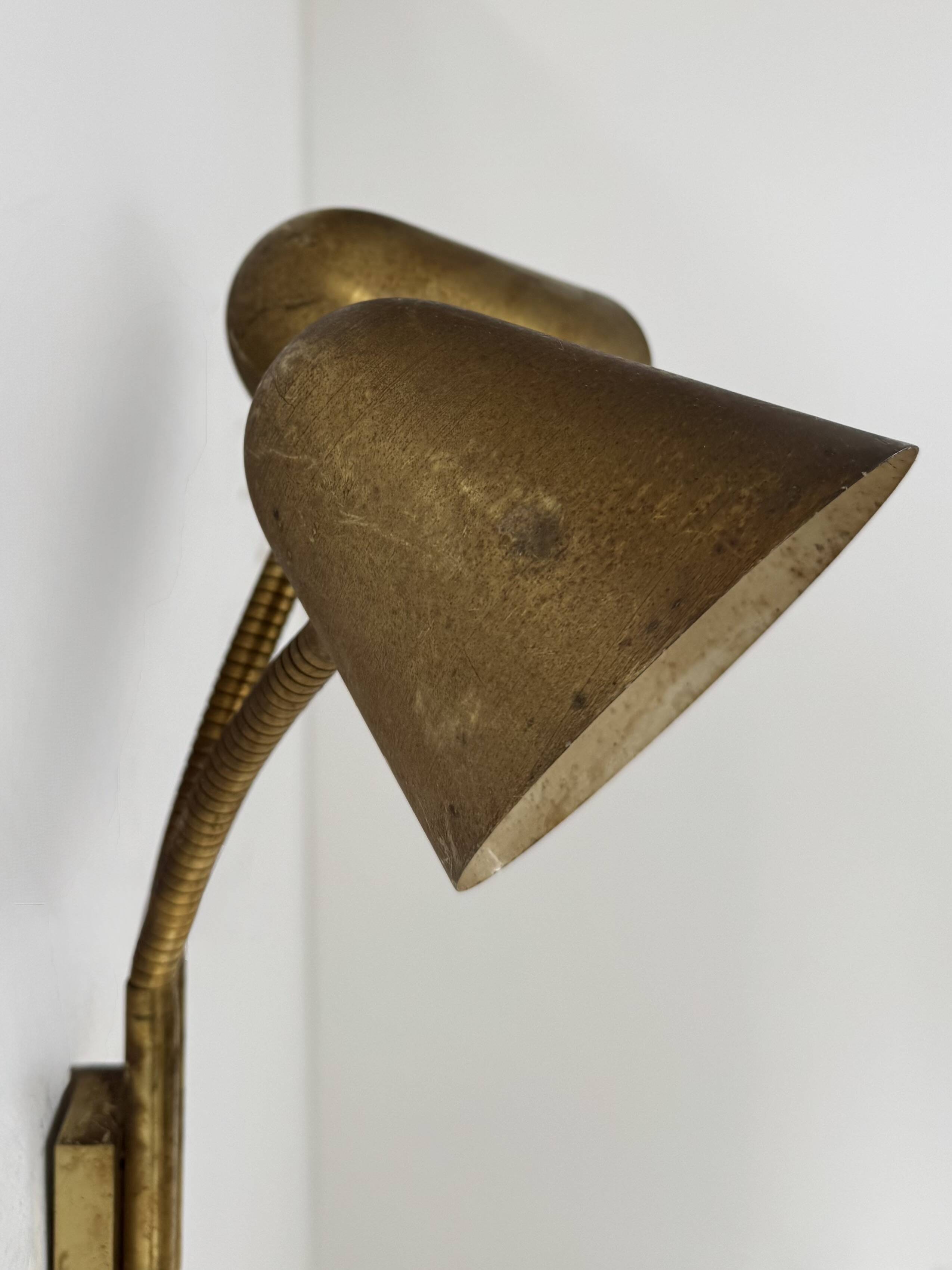 Double orientable vintage patinated brass wall light, Jacques Biny France 1950.