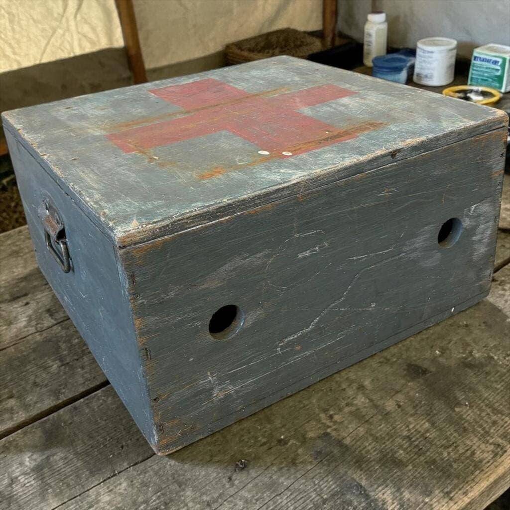 Vintage grey wooden chest with red cross 'first aid'
