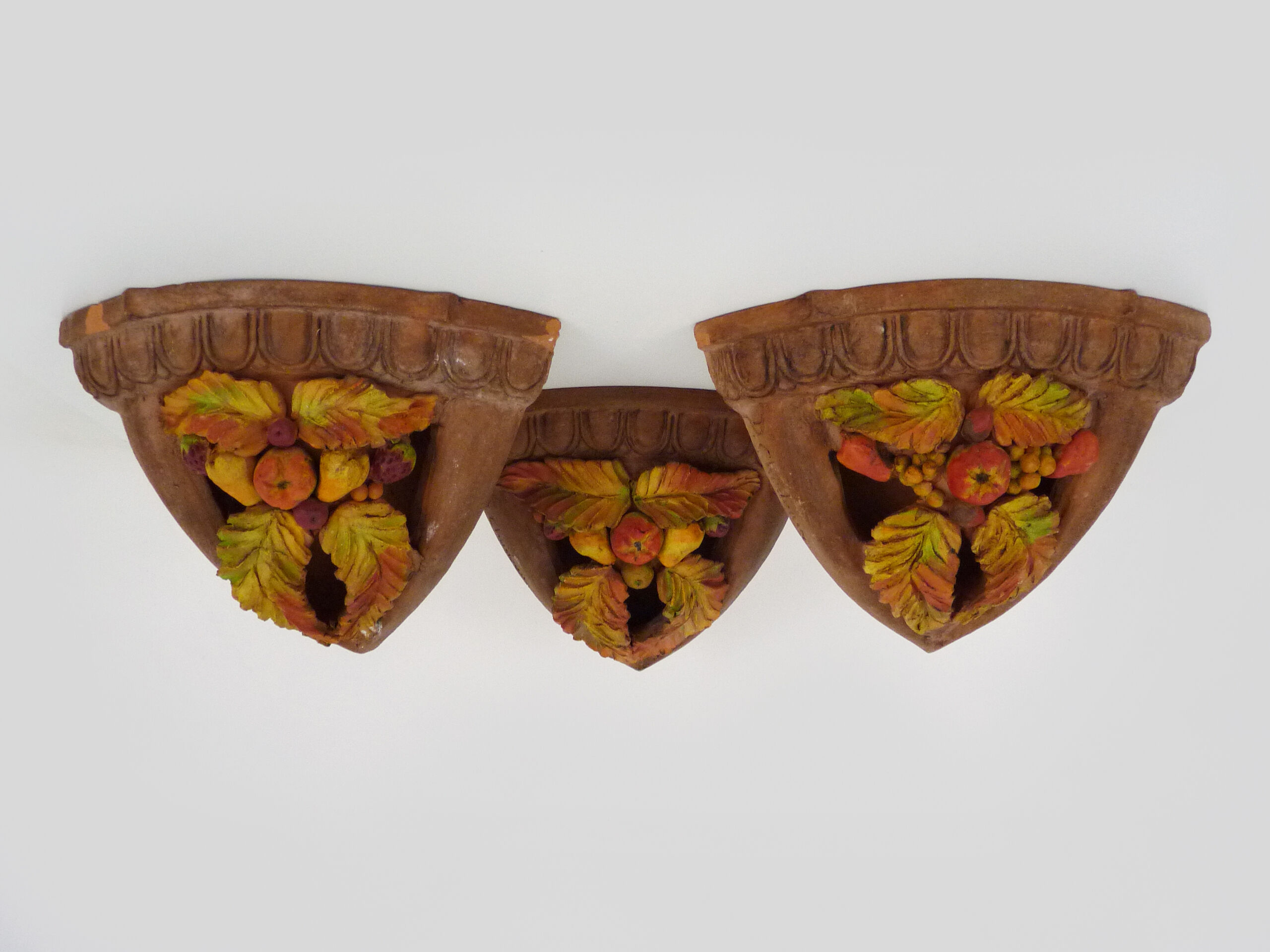 Corner wall lamp in terracotta with fruit decoration, signed D.Chadeau