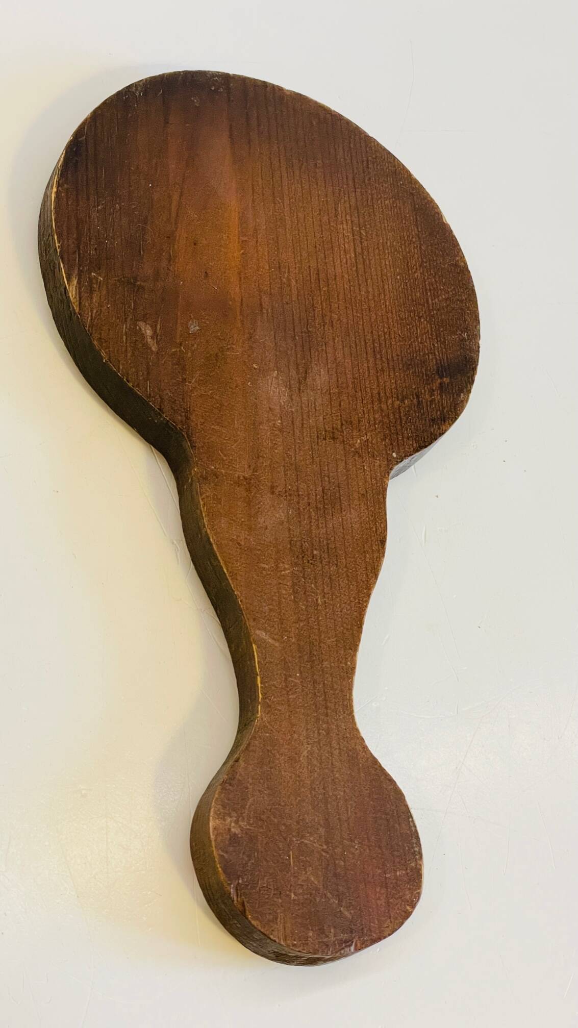 Vintage enameled metal hand mirror on wood