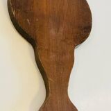 Vintage enameled metal hand mirror on wood