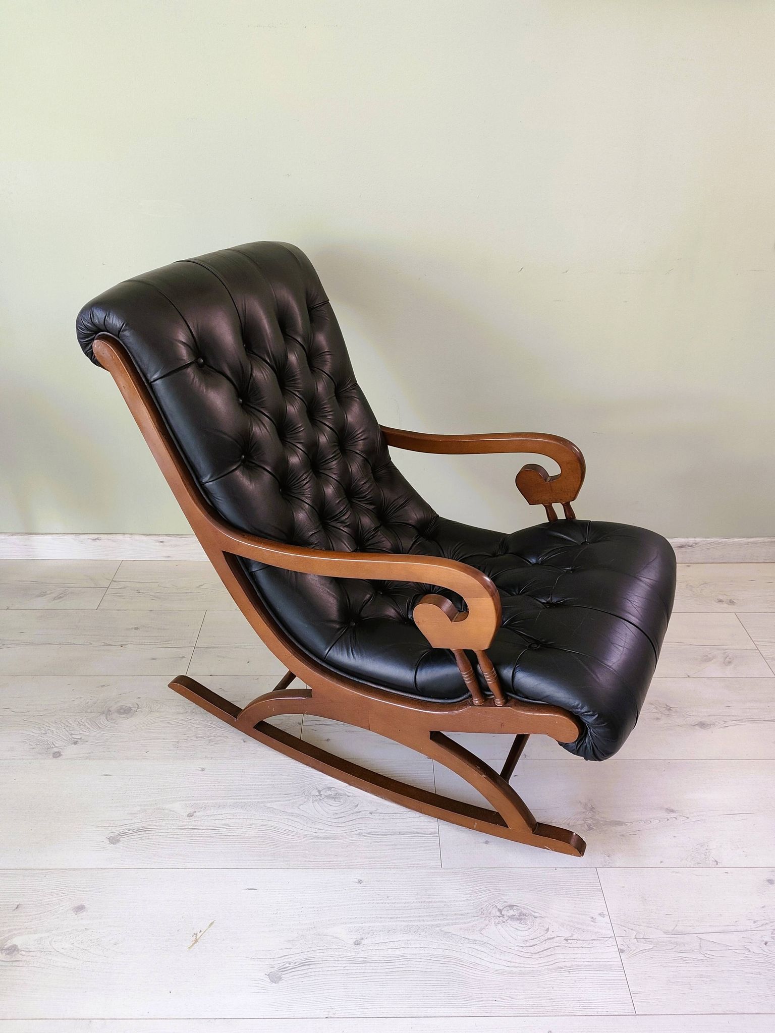 Black leather rocking Chesterfield armchair