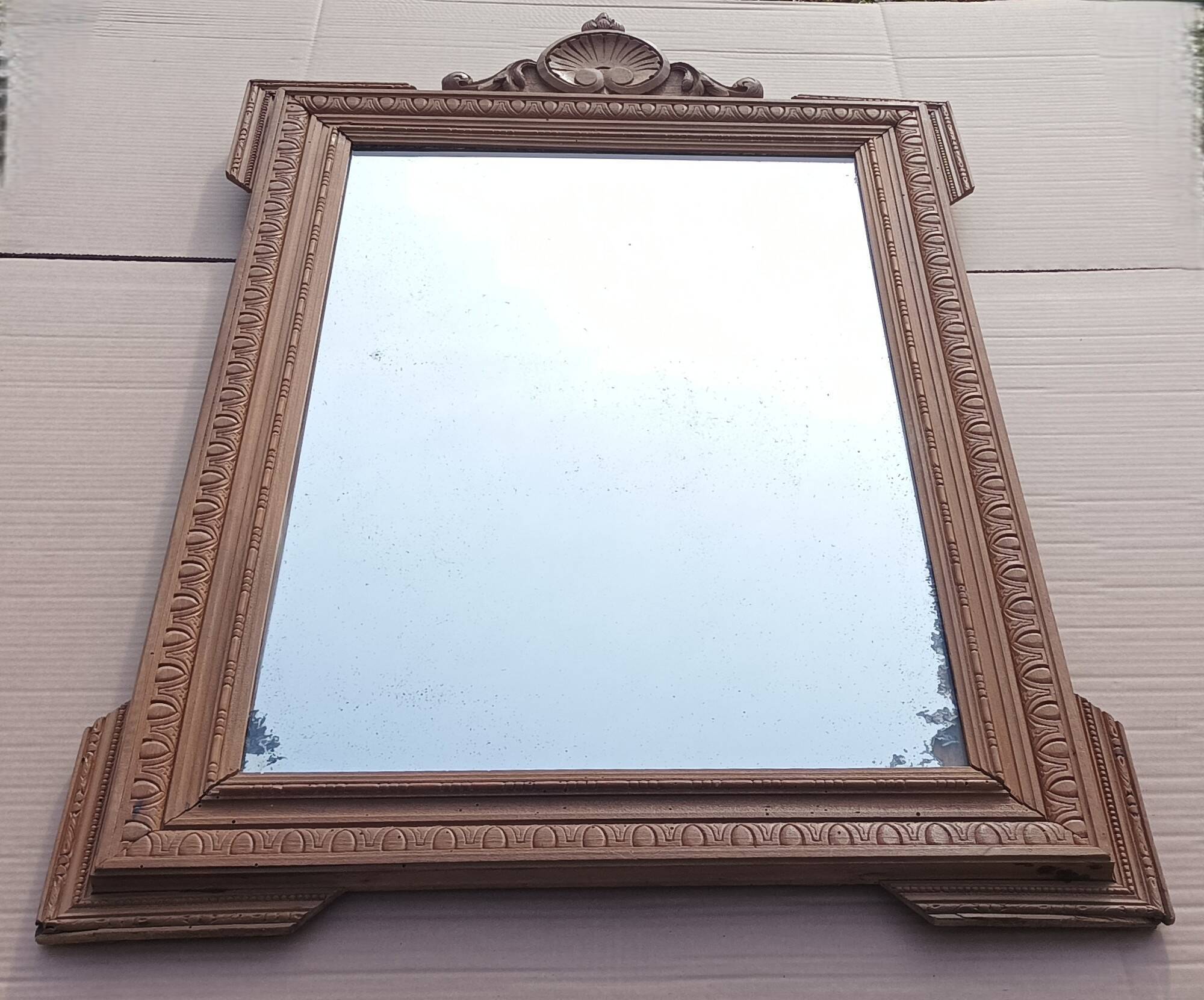 Louis XVI mirror in carved wood, 19th century.