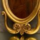 Oval view mirror in gilded wood with leafy decoration in Regency style