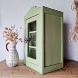 Small glass cabinet in green colour.