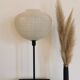 Table lamp with a white striped glass globe lampshade and a gold base