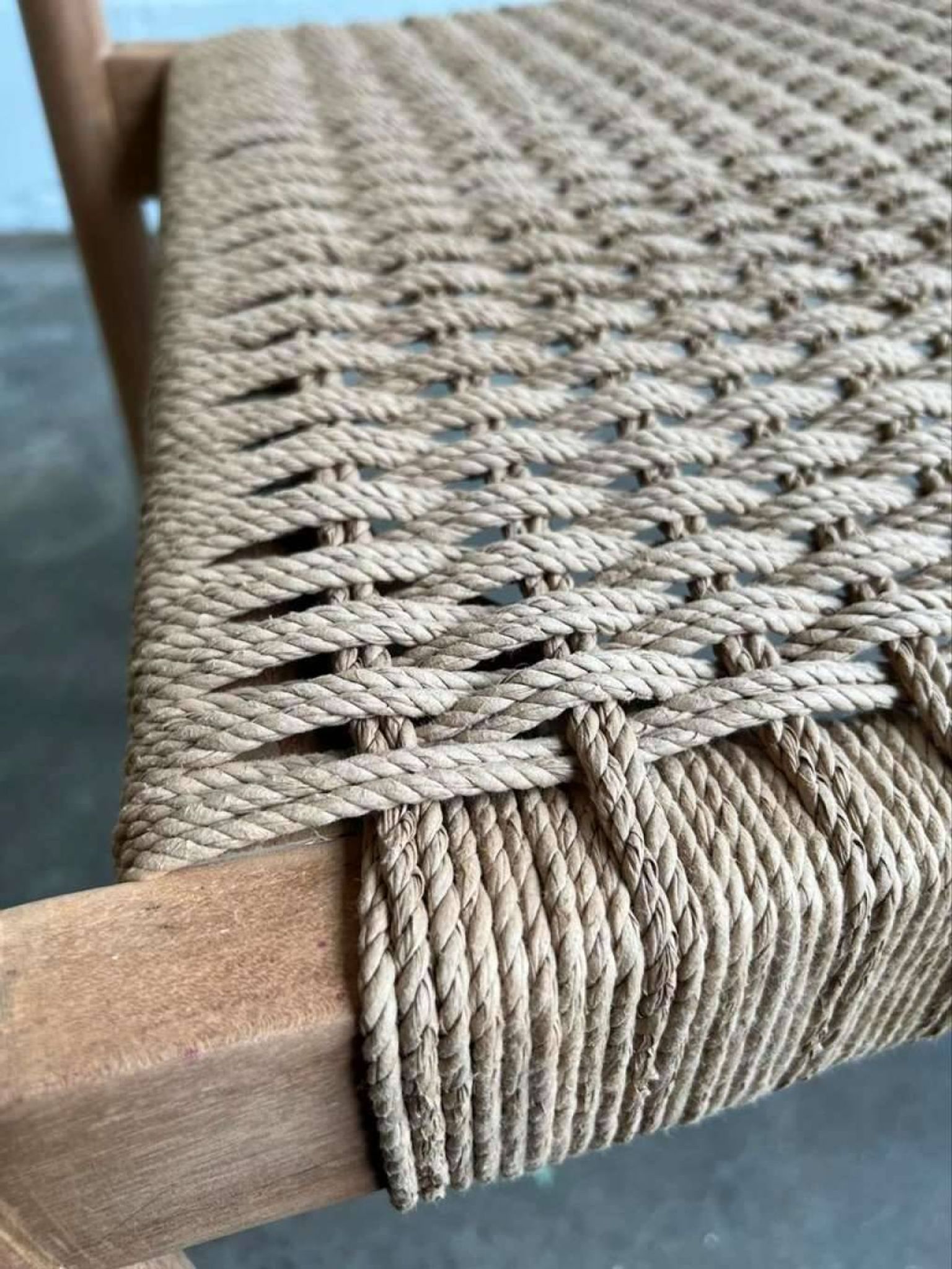 Solid wood chair with weaved seat and armrests