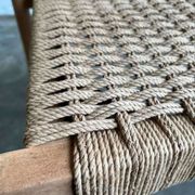 Solid wood chair with weaved seat and armrests
