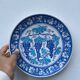 Blue decorative plate with grapes