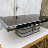 Coffee table with chrome base and mirrored glass top, vintage solar flare decor