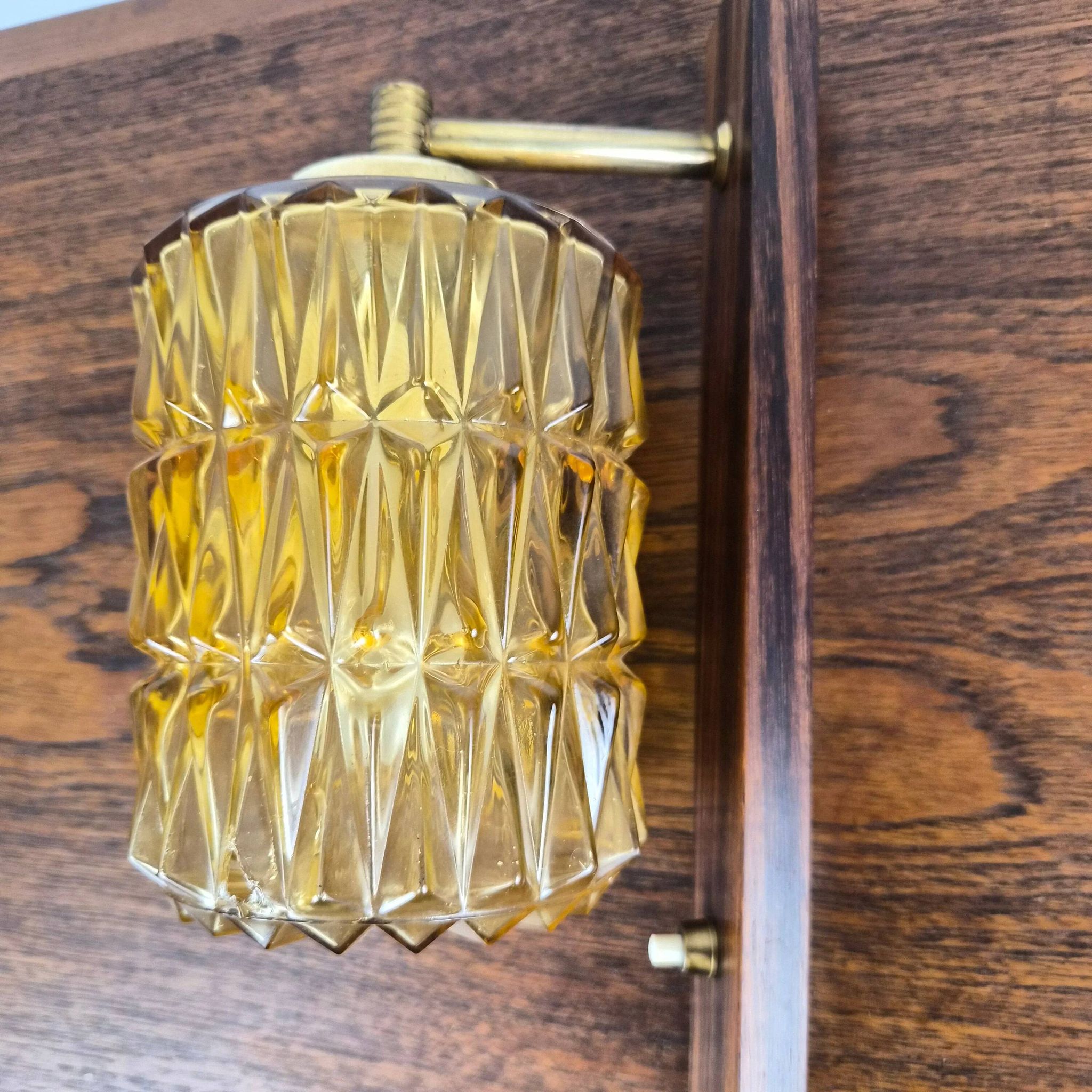 Wall lamp in rosewood, brass and glass, Denmark, 1960.