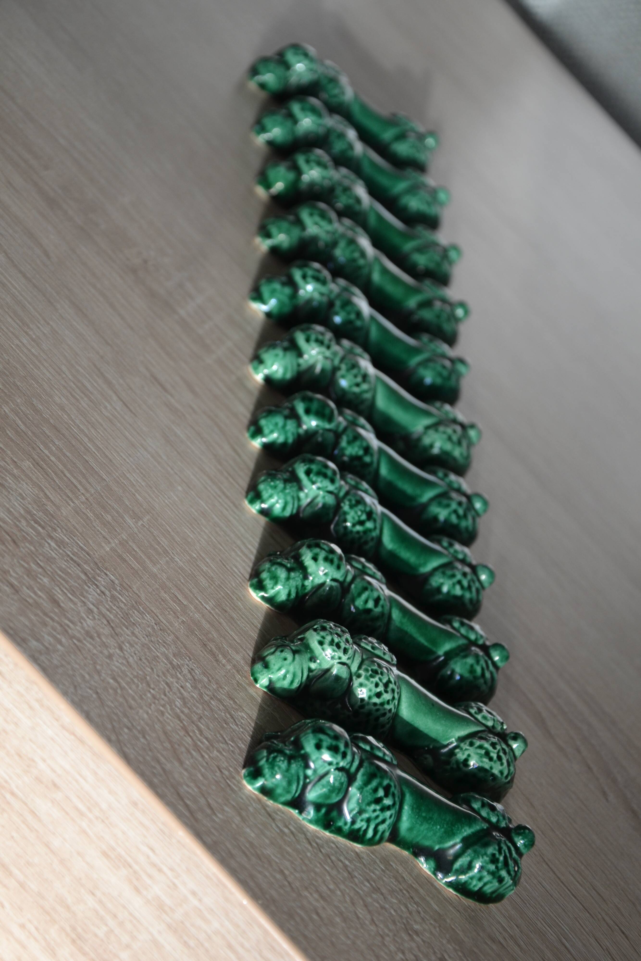 12 green earthenware knife rests