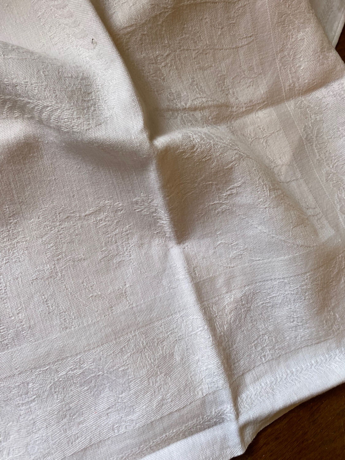 Pair of embroidered white cotton tea towels.