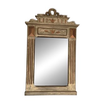 Golden wooden mirror with an ornate pediment in trumeau style.