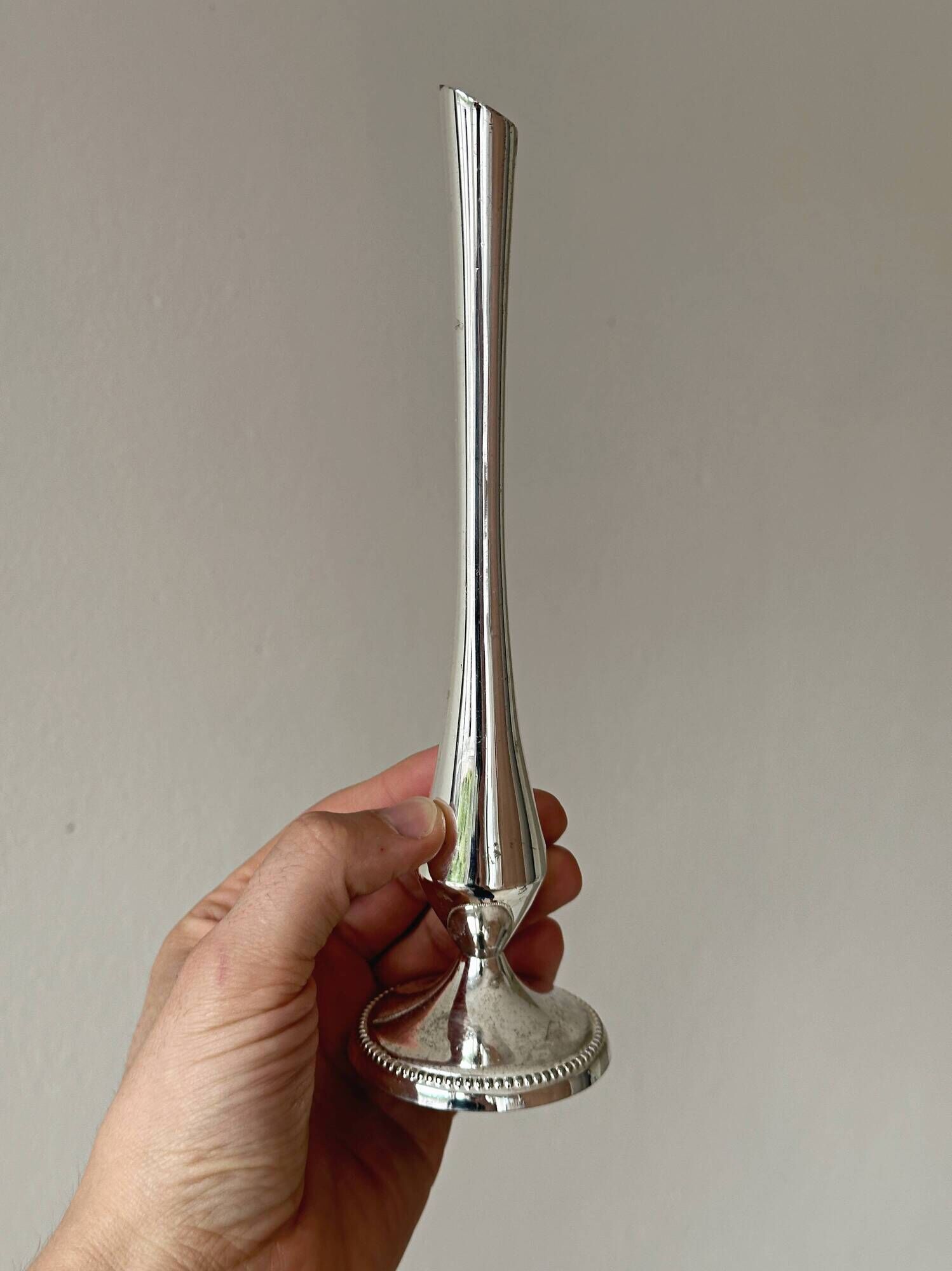 Set of three lightweight silver-coloured metal vases.