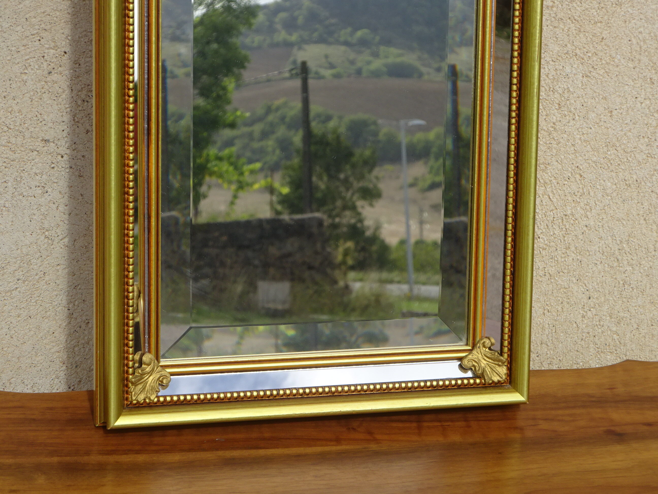 Vertical mirror, gold frame with beading.