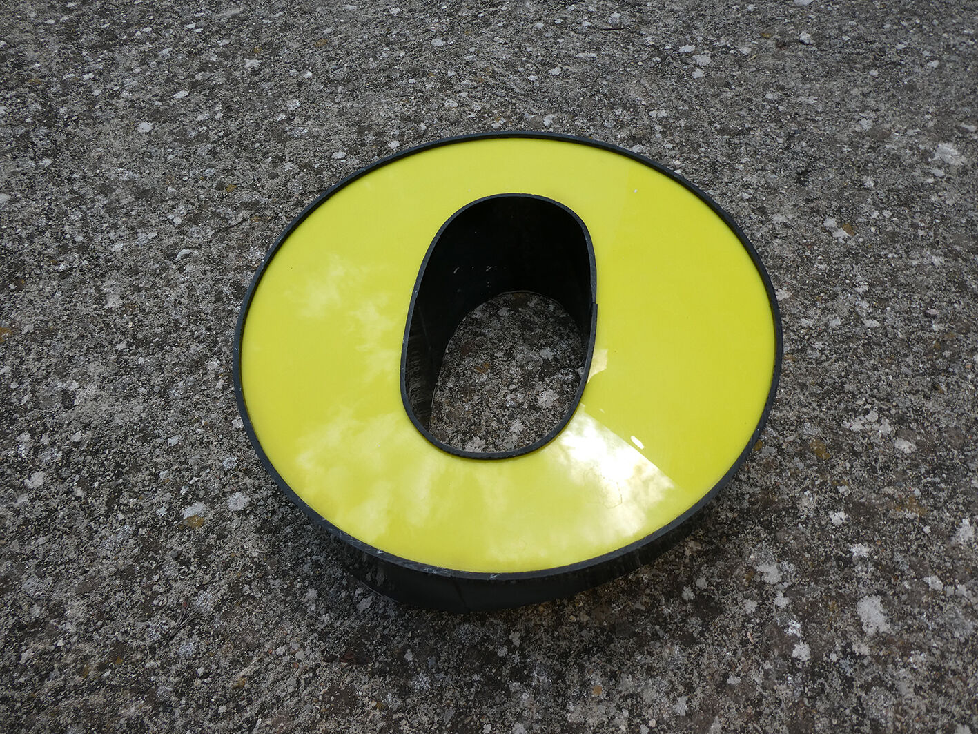 Letter "O" of industrial sign yellow and black